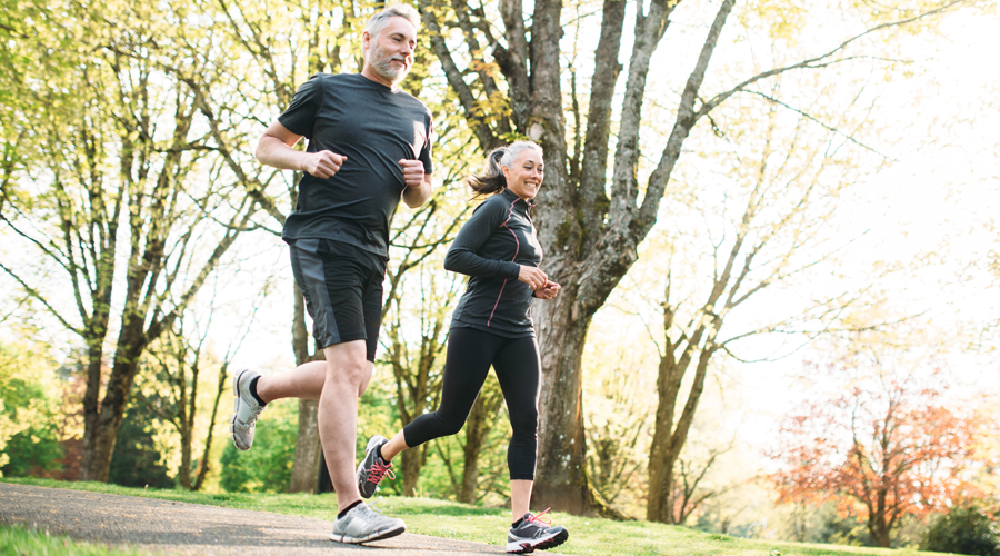 Mature couple running outside