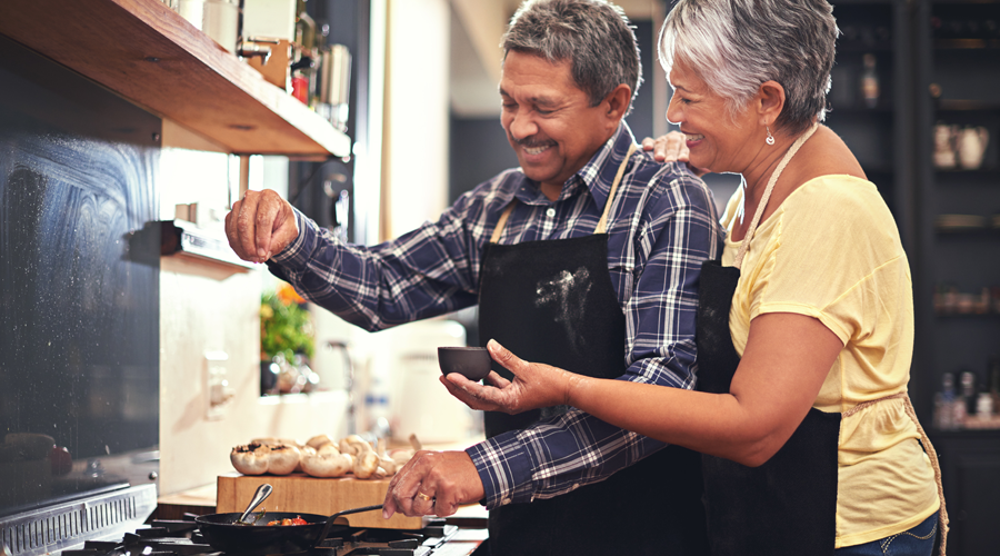 Mature couple cooking together