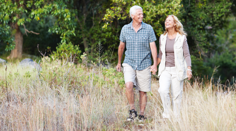 Mature couple walking in the woods