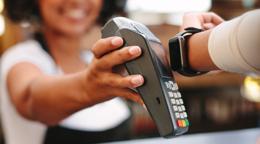 Young individual using Apple Watch to make payment
