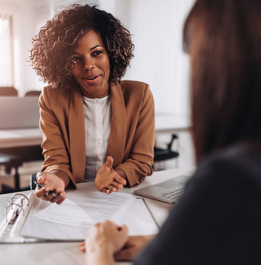 woman talking over documents