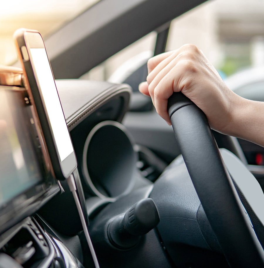 Smartphone on dashboard of car