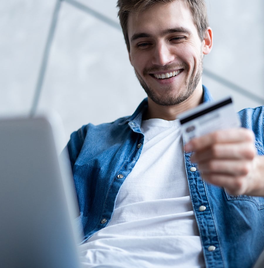 man paying with credit card on laptop