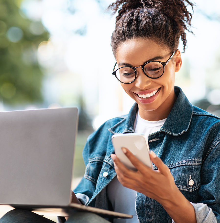 student on cellphone smiling